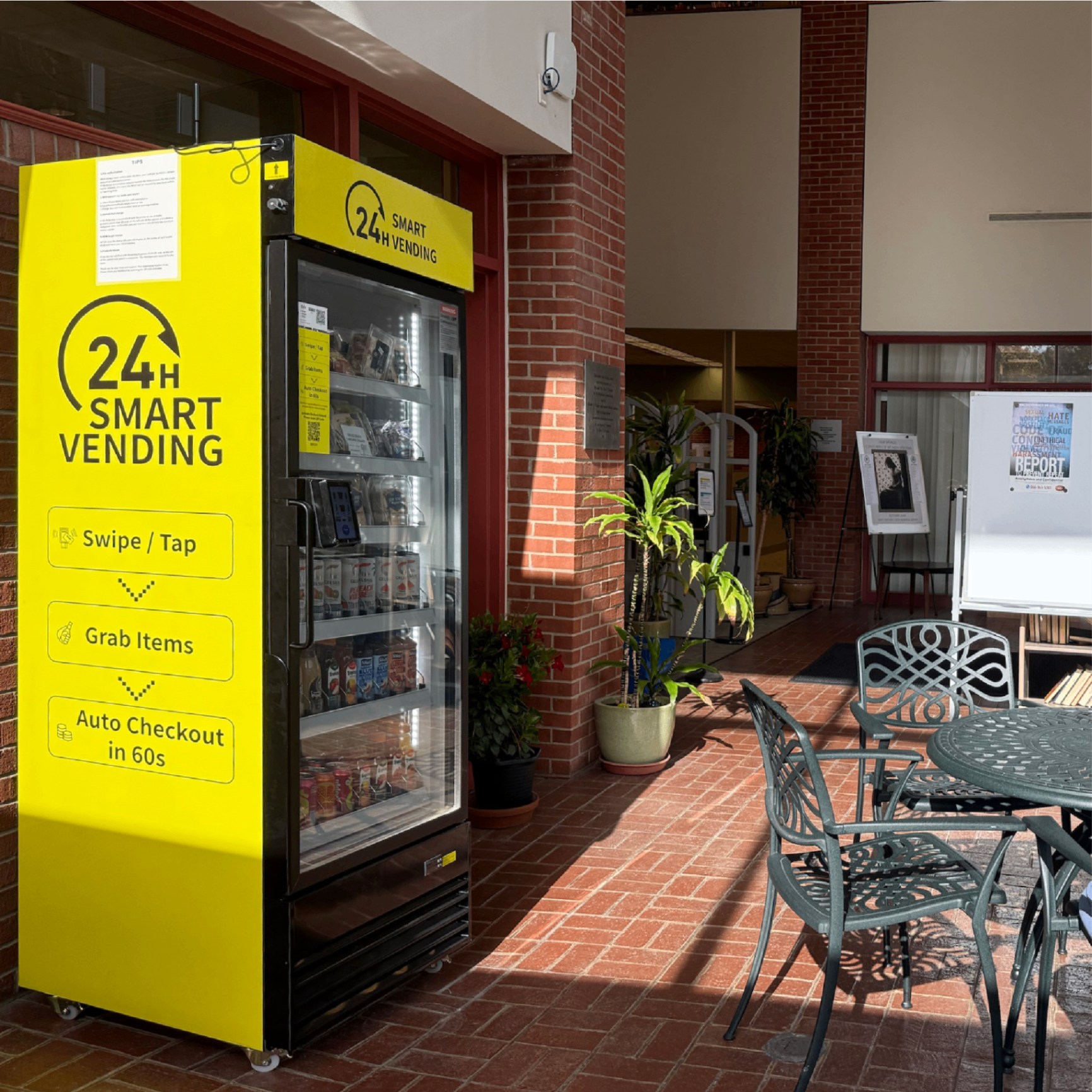 Branded yellow 24H Smart Vending machine in courtyard